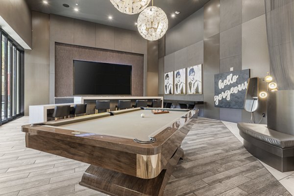 Stylish game room with pool table and lounge seating at The Griffin Apartments