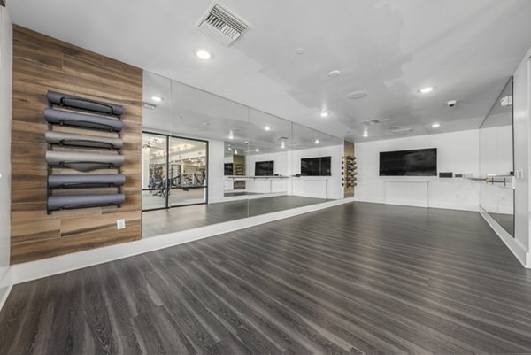 Yoga and spin studio with modern equipment at The Griffin Apartments, a luxury living community