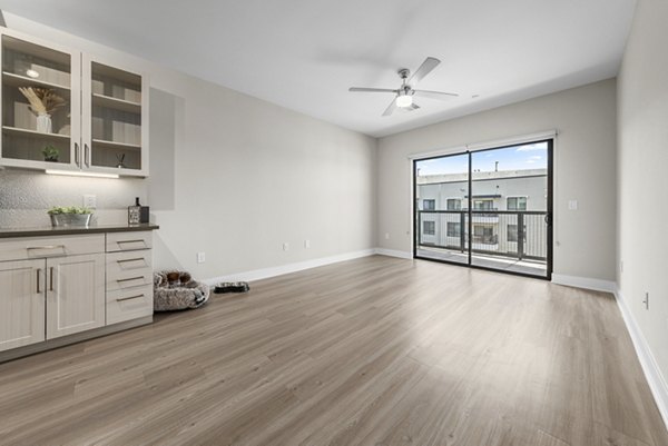 Modern kitchen with stainless steel appliances and quartz countertops in The Griffin Apartments