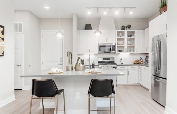 Kitchen with modern appliances and sleek countertops at The Griffin Apartments