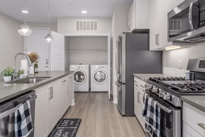 Contemporary kitchen with sleek countertops and modern appliances at The Griffin Apartments
