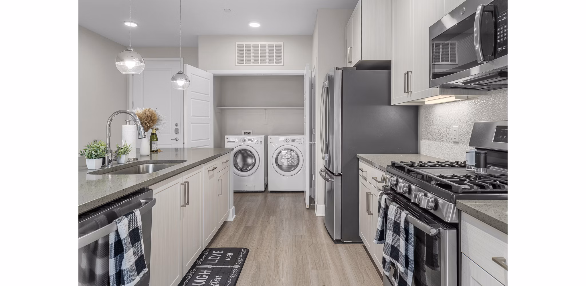 Contemporary kitchen with sleek countertops and modern appliances at The Griffin Apartments
