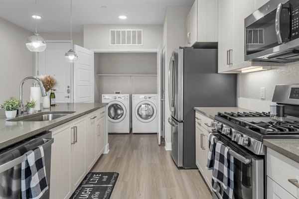 Contemporary kitchen with sleek countertops and modern appliances at The Griffin Apartments