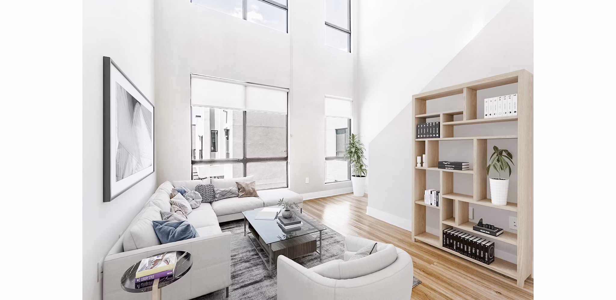 Spacious living room featuring modern decor and ample natural light at The Griffin Apartments