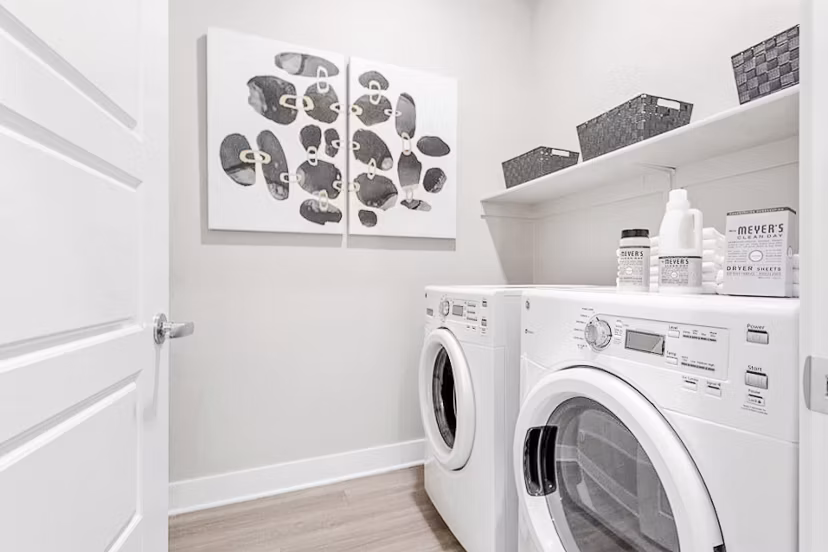 Laundry room with modern appliances at The Griffin Apartments