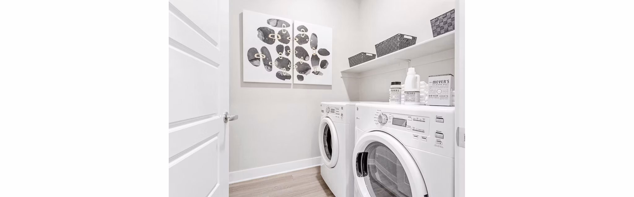 Laundry room with modern appliances at The Griffin Apartments