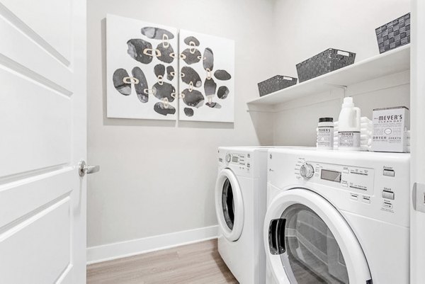 Laundry room with modern appliances at The Griffin Apartments