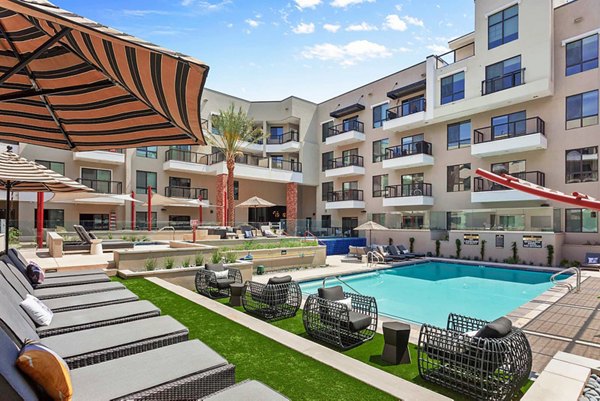 Resort-style pool with lounge chairs at The Griffin Apartments