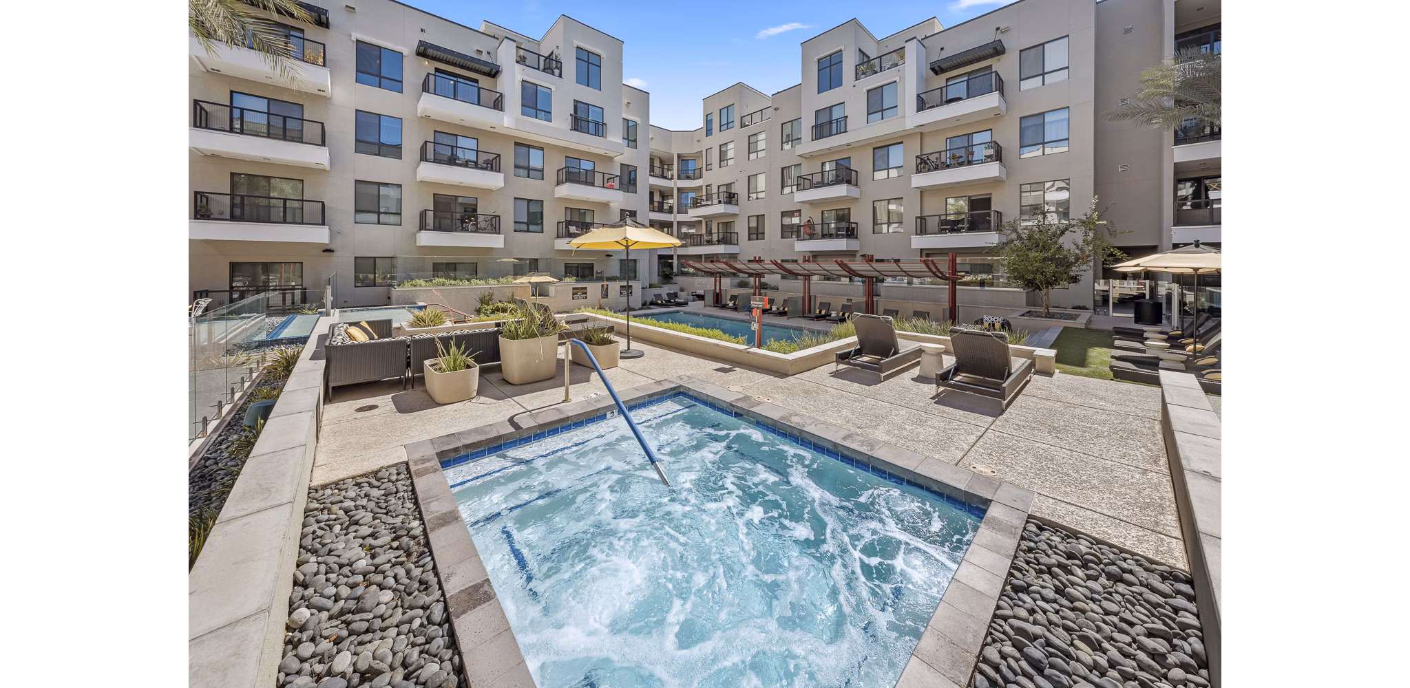 Infinity-edge pool with lounge seating at The Griffin Apartments