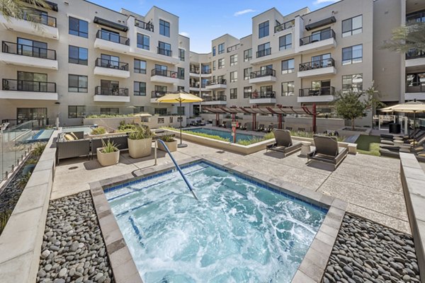 Infinity-edge pool with lounge seating at The Griffin Apartments