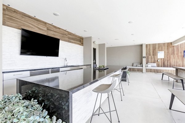 The Griffin Apartments: Lush courtyard garden with modern seating areas in vibrant city setting