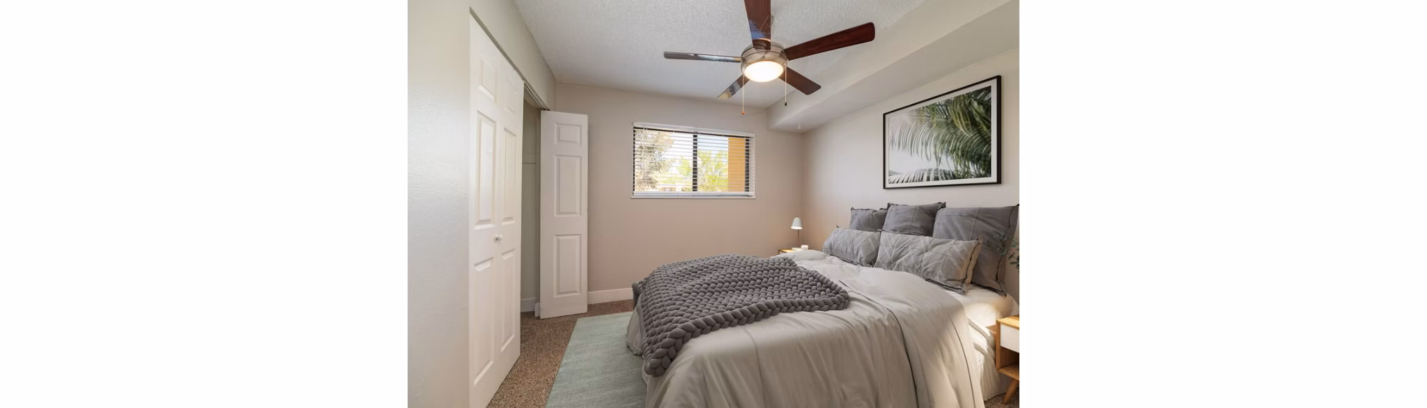 Elegant bedroom with modern furnishings at Tesota Midtown Apartments