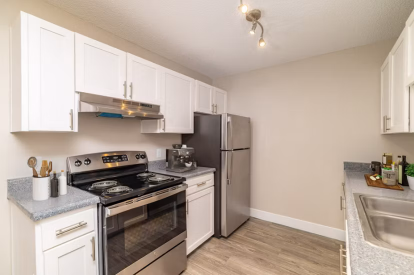 Modern kitchen with stainless steel appliances in Tesota Midtown Apartments