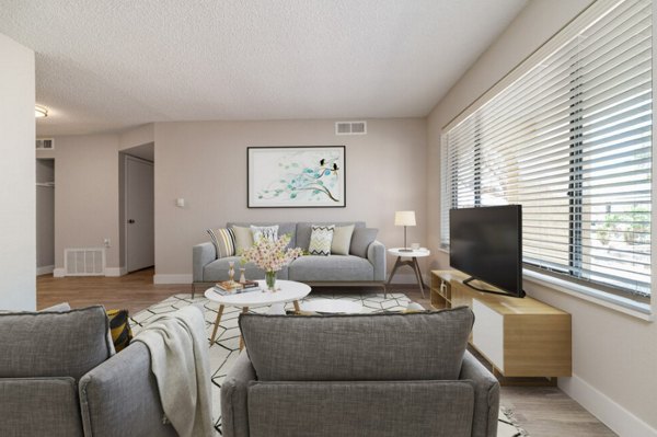 Modern living room with stylish decor and ample natural light at Prado Apartments, luxury property by Greystar