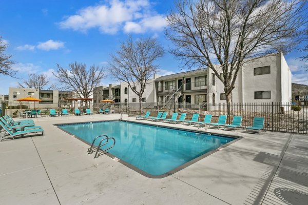 Tesota Midtown Apartments: Sunlit outdoor pool with modern lounge chairs