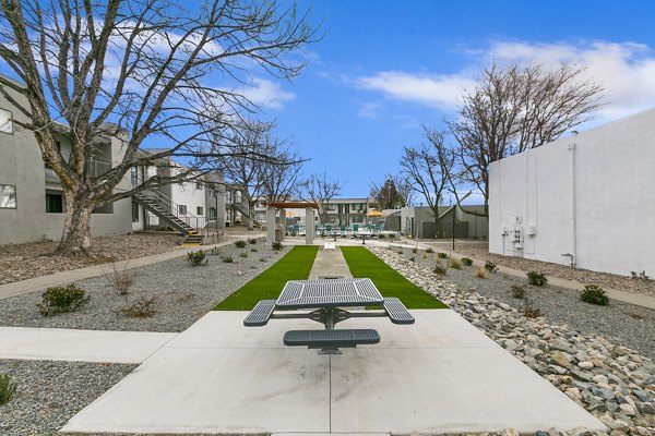 Courtyard with lush landscaping and seating area at Tesota Midtown Apartments, a luxury apartment community by Greystar