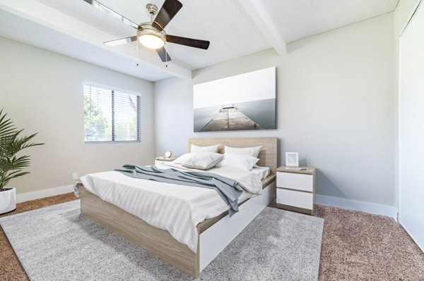 Bedroom with modern decor and large windows in Tesota Morningside Apartments