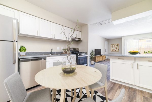 Kitchen and dining room with modern appliances and sleek finishes at Tesota Morningside Apartments, luxury living by Greystar