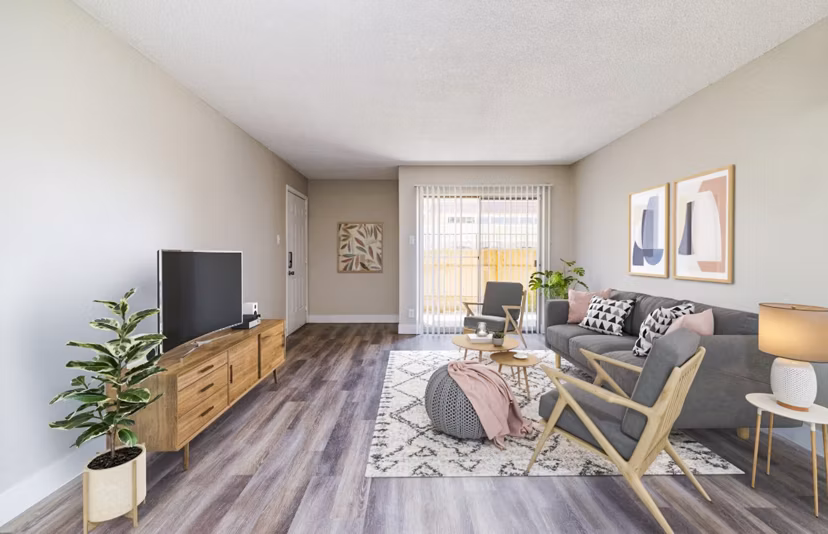 Spacious living room with modern decor and large windows in Tesota Morningside Apartments