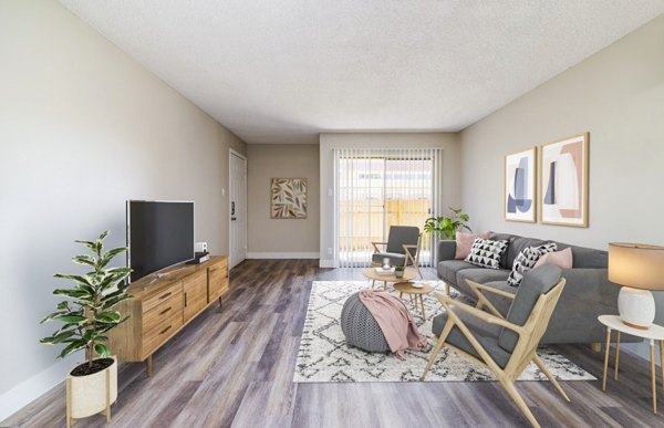 Spacious living room with modern decor and large windows in Tesota Morningside Apartments