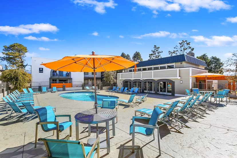 Olympic-sized pool with lounging area at Tesota Morningside Apartments, offering luxurious relaxation and recreation for residents