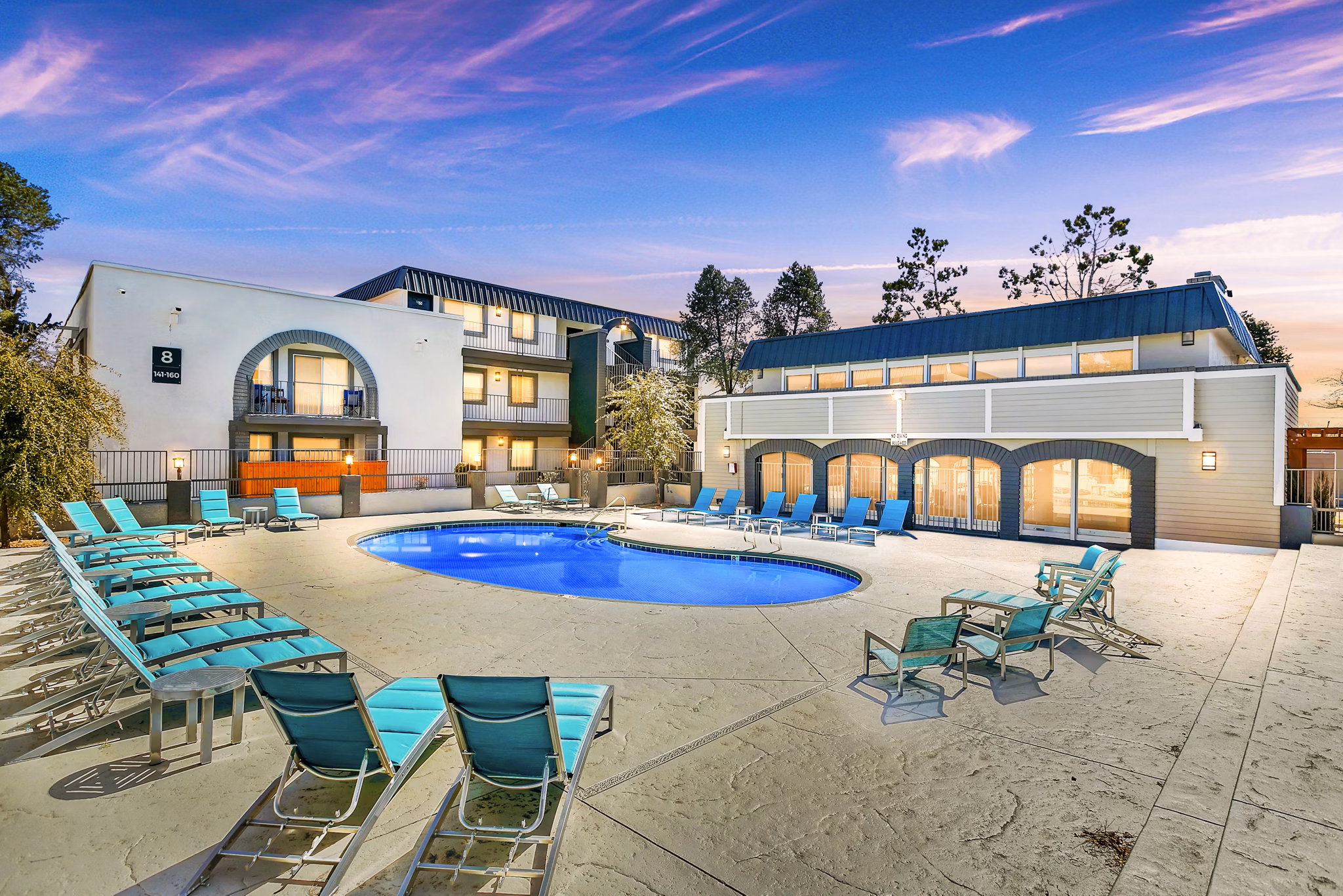 Resort-style outdoor pool at Tesota Morningside Apartments offers luxury relaxation amidst lush landscapes