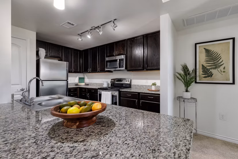 Kitchen featuring modern appliances and quartz countertops at Aviva Fort Worth Apartments