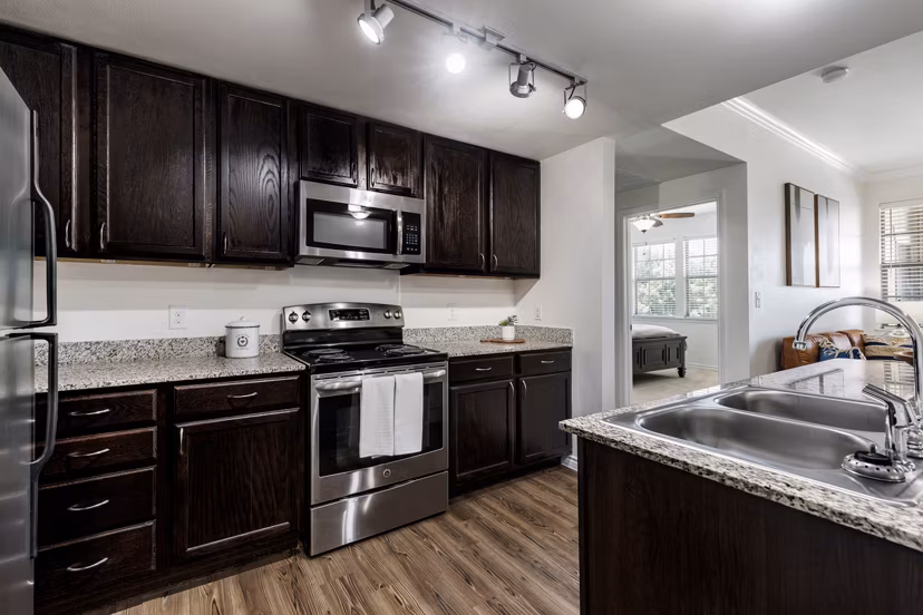 Modern kitchen with stainless steel appliances and granite countertops at Aviva Fort Worth Apartments