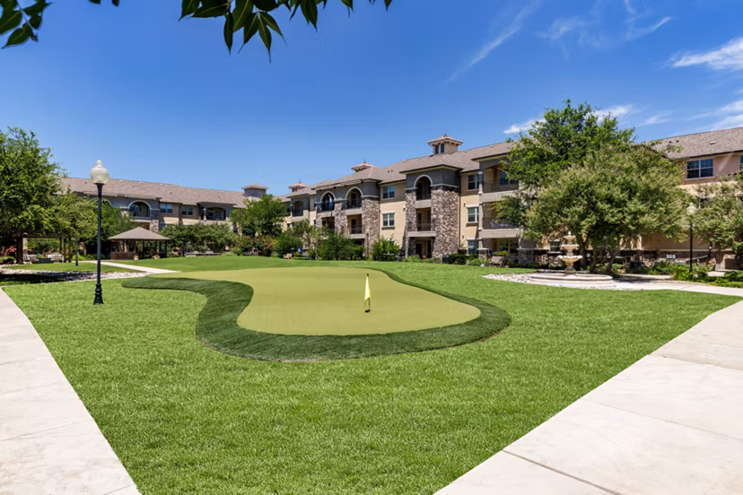Putting green at Aviva Fort Worth Apartments featuring manicured lawns and scenic surroundings