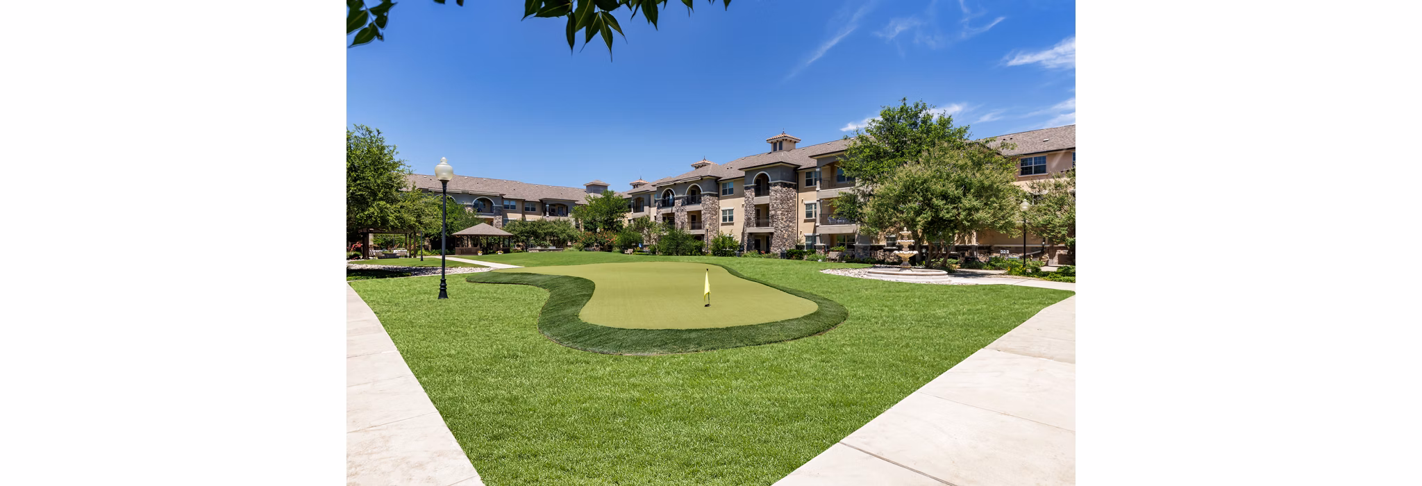 Putting green at Aviva Fort Worth Apartments featuring manicured lawns and scenic surroundings