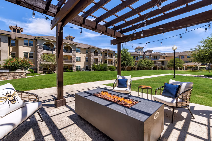Cozy outdoor fire pit area at Aviva Fort Worth Apartments, ideal for social gatherings and relaxation in luxury surroundings