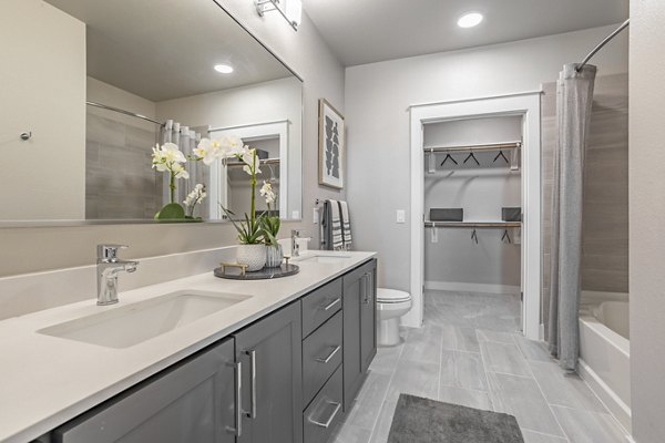 Modern bathroom with sleek fixtures and spacious layout in Filament Apartments