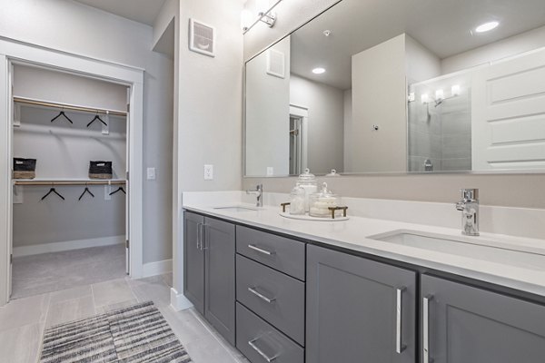 Modern bathroom featuring sleek fixtures and bright lighting at Filament Apartments
