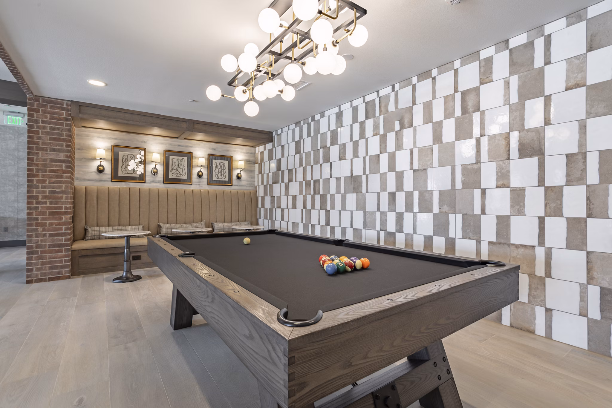 Game room featuring billiards and arcade games at Filament Apartments luxury community