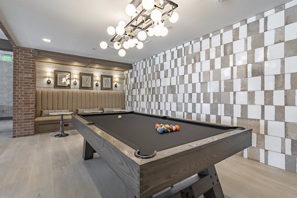 Game room featuring billiards and arcade games at Filament Apartments luxury community
