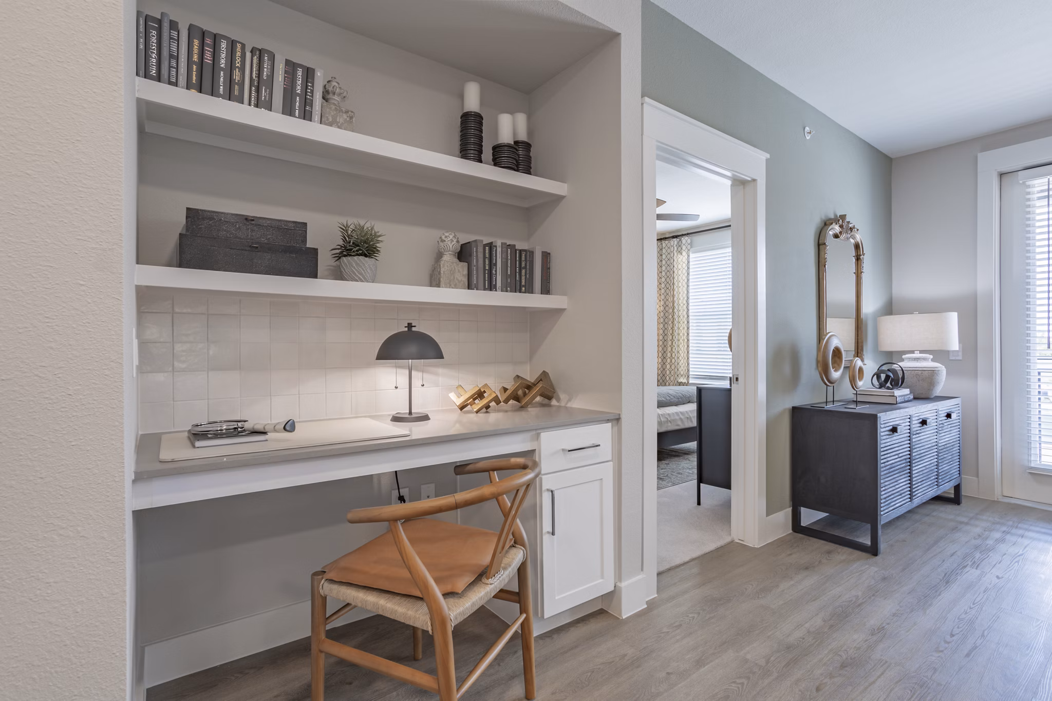 Home office with ergonomic chair and large desk in Filament Apartments Ideal for remote work with modern dÃ©cor and ample natural light
