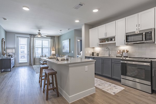 Modern kitchen with sleek countertops and stainless steel appliances at Filament Apartments