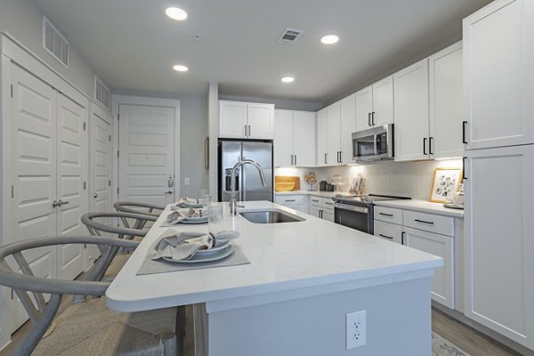 Modern kitchen with stainless steel appliances in Filament Apartments
