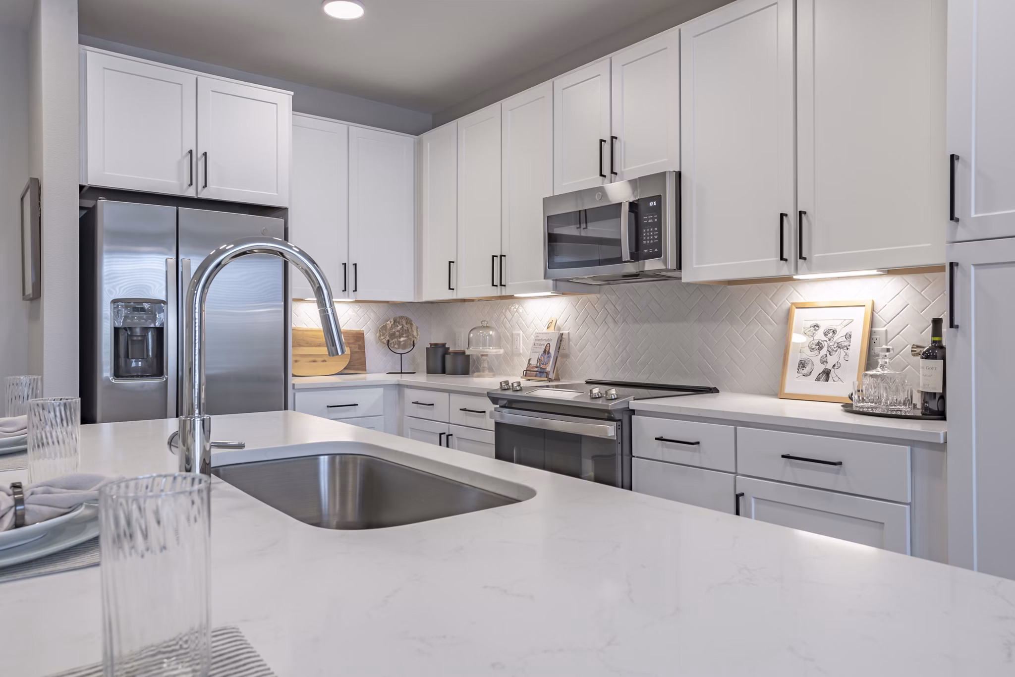 Modern kitchen with stainless steel appliances at Filament Apartments luxury units