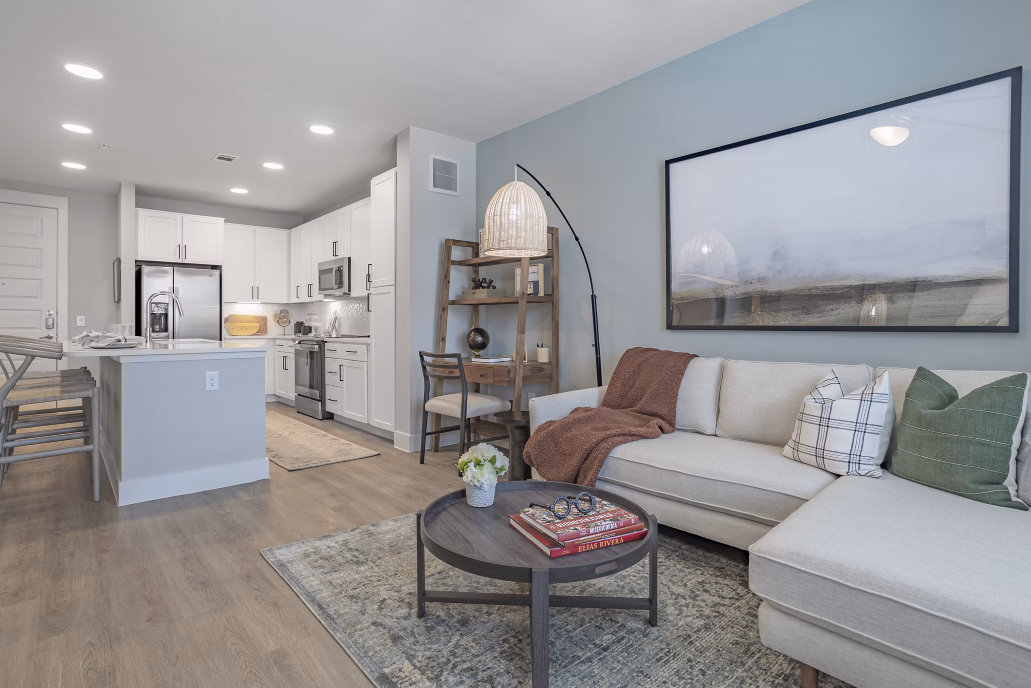 Spacious living room with modern decor featuring natural light at Filament Apartments