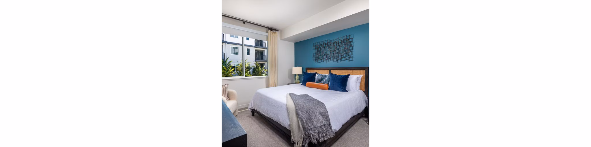 Bedroom featuring elegant decor and plush bedding at Paloma Apartments, luxury living by Greystar