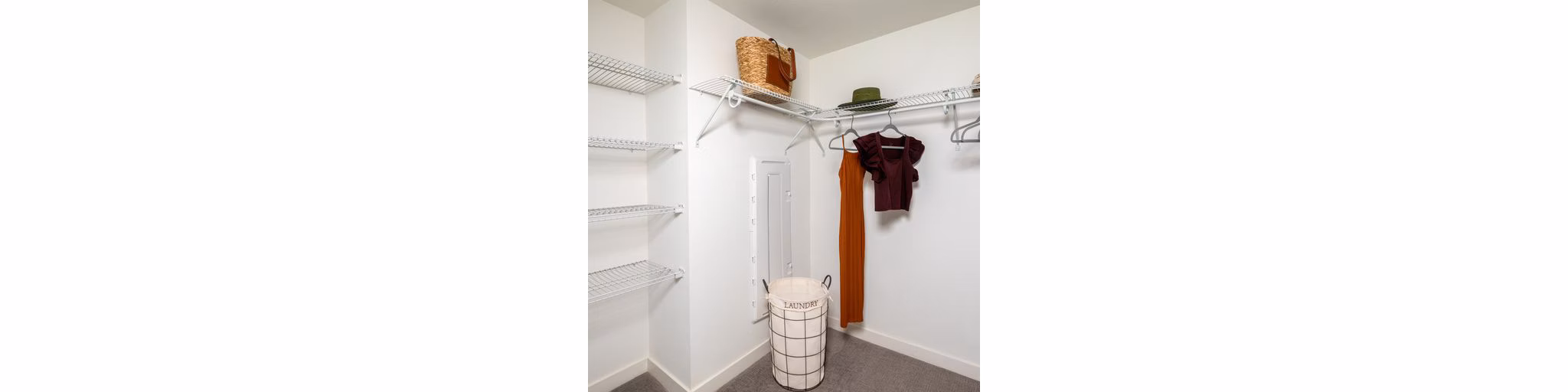 Spacious walk-in closet with custom shelving in a luxury apartment at Paloma Apartments