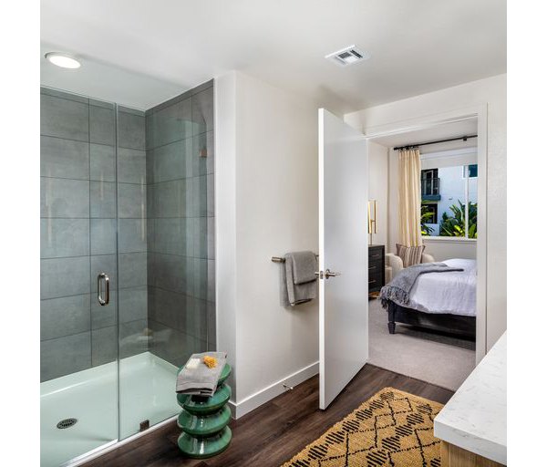 Modern bathroom featuring sleek fixtures and tiled shower in Paloma Apartments