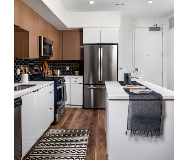 Modern kitchen featuring stainless steel appliances and granite countertops in Paloma Apartments