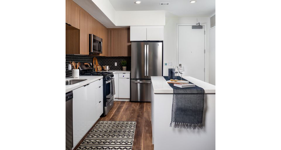Modern kitchen featuring stainless steel appliances and granite countertops in Paloma Apartments