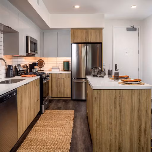 Modern kitchen featuring sleek countertops and stainless steel appliances in Paloma Apartments for luxury living