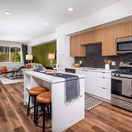 Modern kitchen with stainless steel appliances and granite countertops in Paloma Apartments