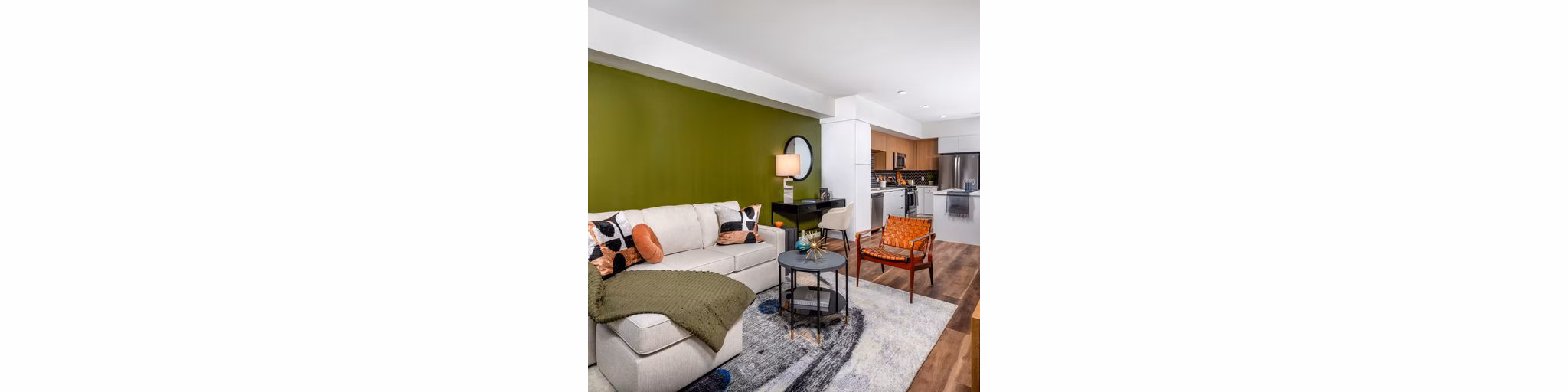 Spacious living room with modern decor at Paloma Apartments, featuring comfortable seating and large windows