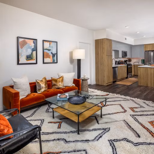 Modern living room with stylish furniture and abundant natural light at Paloma Apartments, a luxury property by Greystar