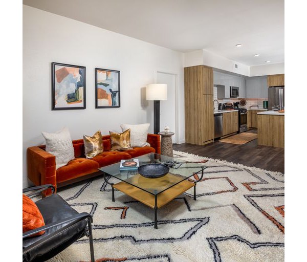 Modern living room with stylish furniture and abundant natural light at Paloma Apartments, a luxury property by Greystar